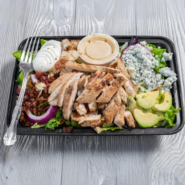 A Marc's Pizzeria and Grill salad with grilled chicken, avocado, bacon, blue cheese, and hard-boiled egg.