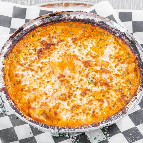A baked ziti pasta dish from Marc's Pizzeria and Grill, topped with melted cheese and herbs.